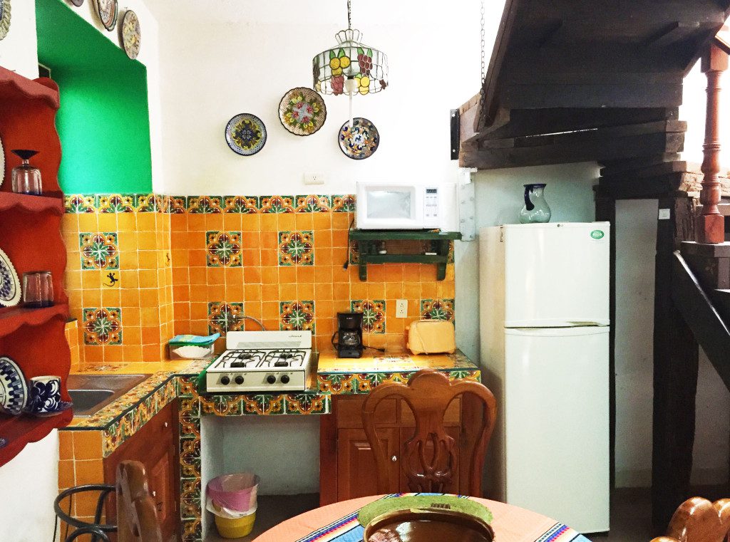 Downstairs Kitchen with refrigerator, stove, sink, pots/pans, dishes, and silverware.