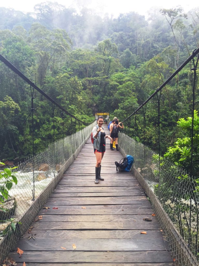 Crossing a raging river in the jungle in Ecuador Julia in the Amazon Rainforest, Tena, Ecuador