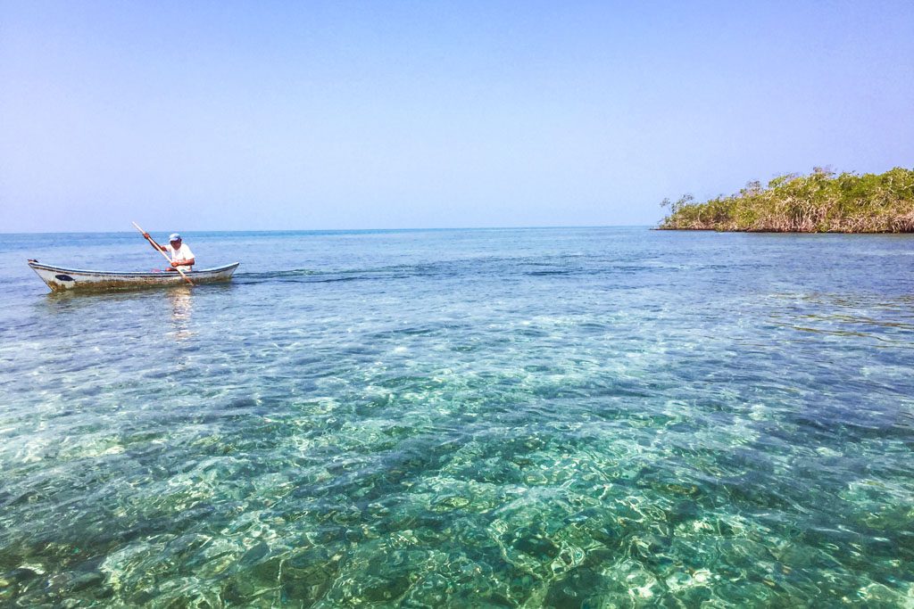 Man on boat at Tintipan Island, San Bernardo Islands, Colombia