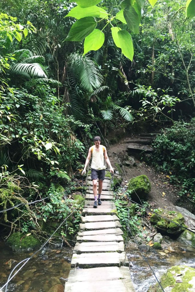 Justin crossing a suspension bridge hiking Valle de Cocora