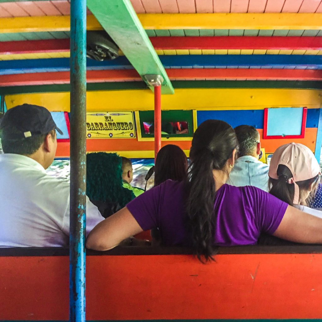 Riding in an open air Chiva. chiva travel latin america