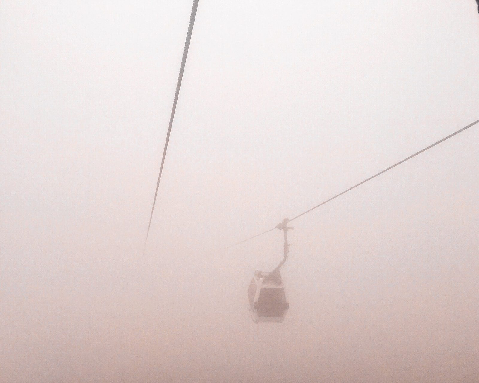 Traveling up a misty mountain by cable car in Ecuador. cable car travel latin america