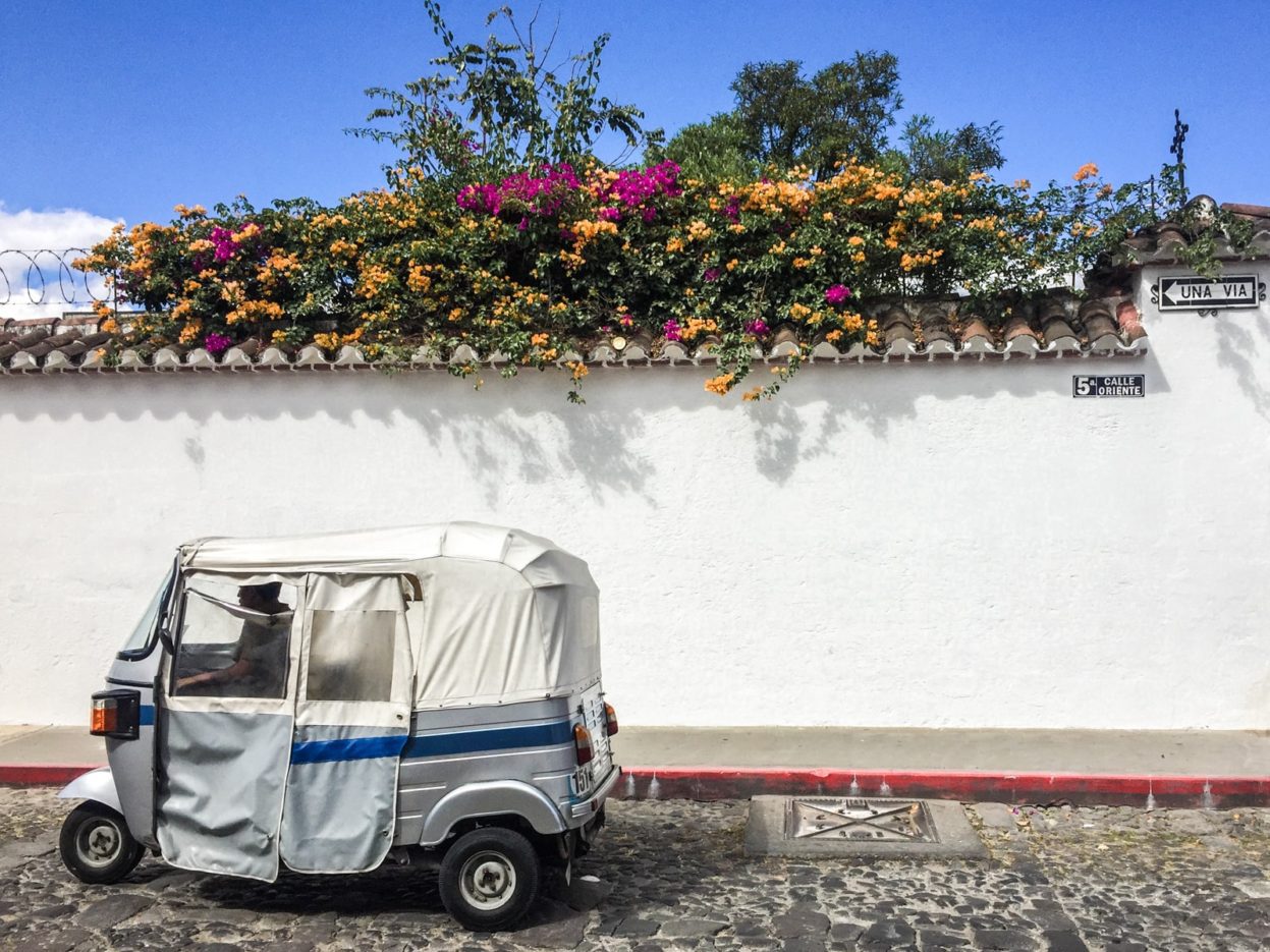 A tuk tuk on a picturesque street in Guatemala tuk tuk guatemala